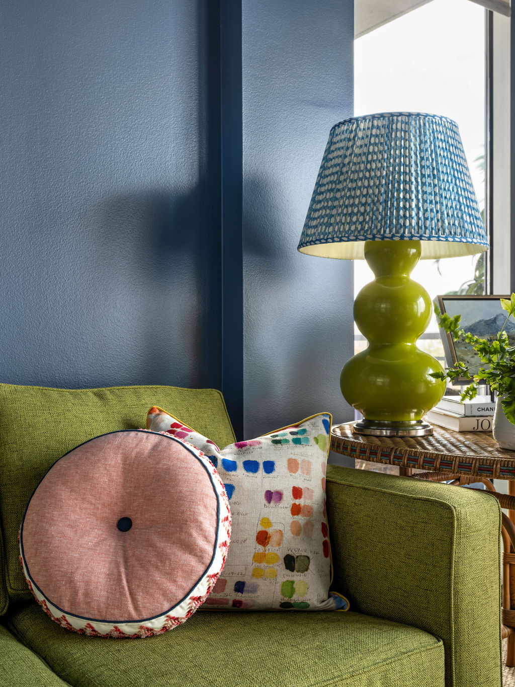 Styled dorm desk with brass lamp, blue and white ginger jar, and scalloped corkboard
