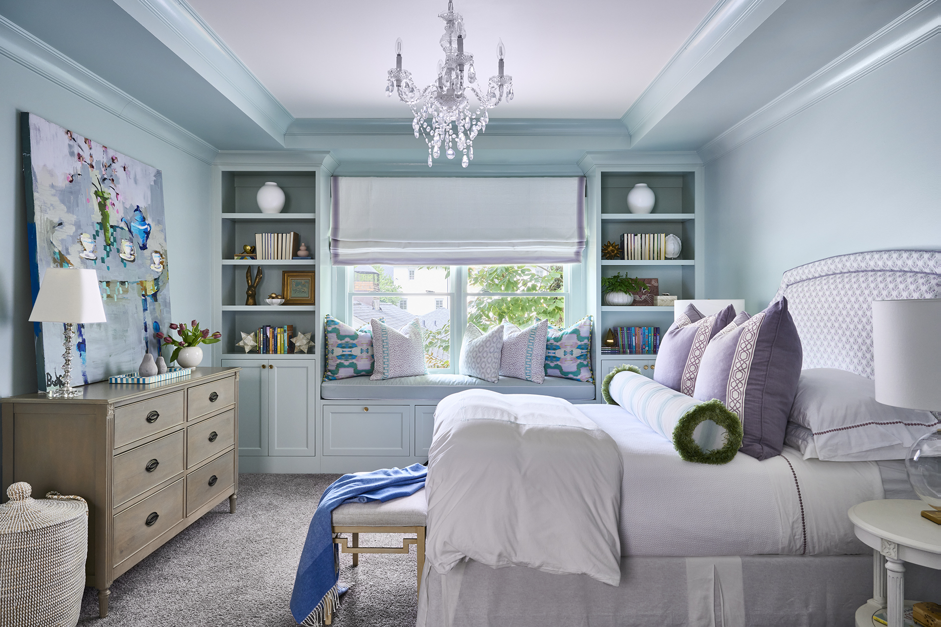 Designed dorm room with lavender pillows, scalloped trim, and a built-in window seat