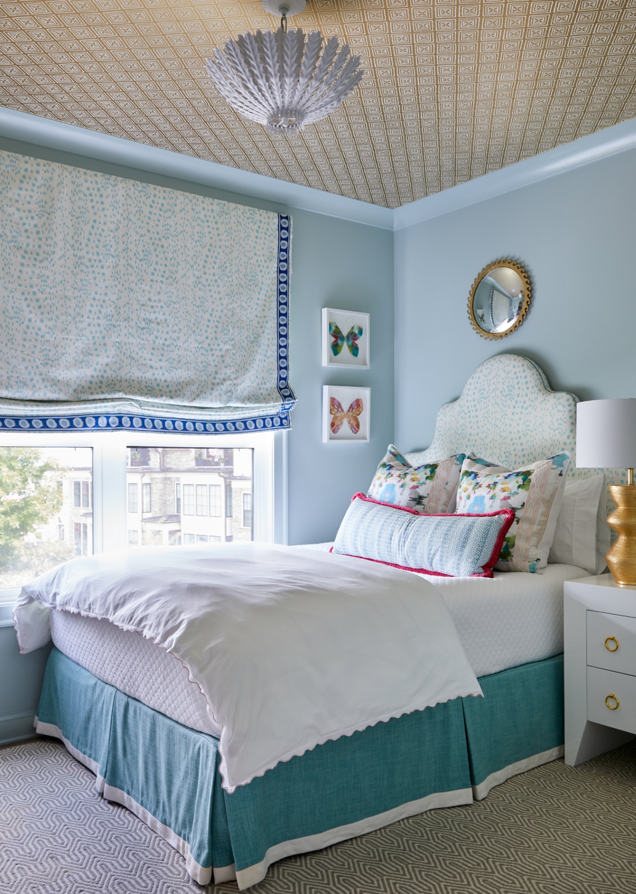 Designed dorm room install with dusty blue scalloped headboard